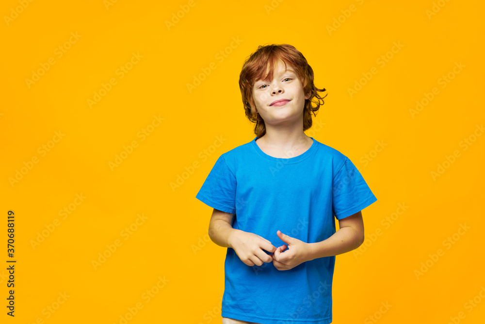 red-haired child smiling at the camera studio shot yellow isolated background red-haired child smiling at the camera studio shot yellow isolated background