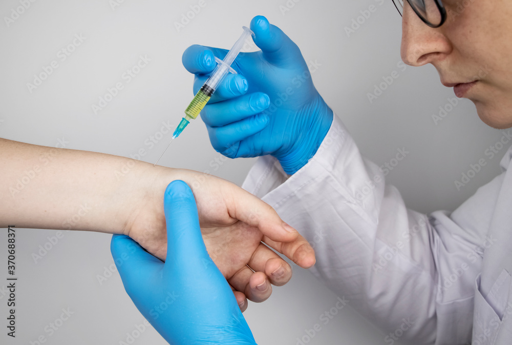 An orthopedic surgeon gives an injection in the wrist. Treatment of