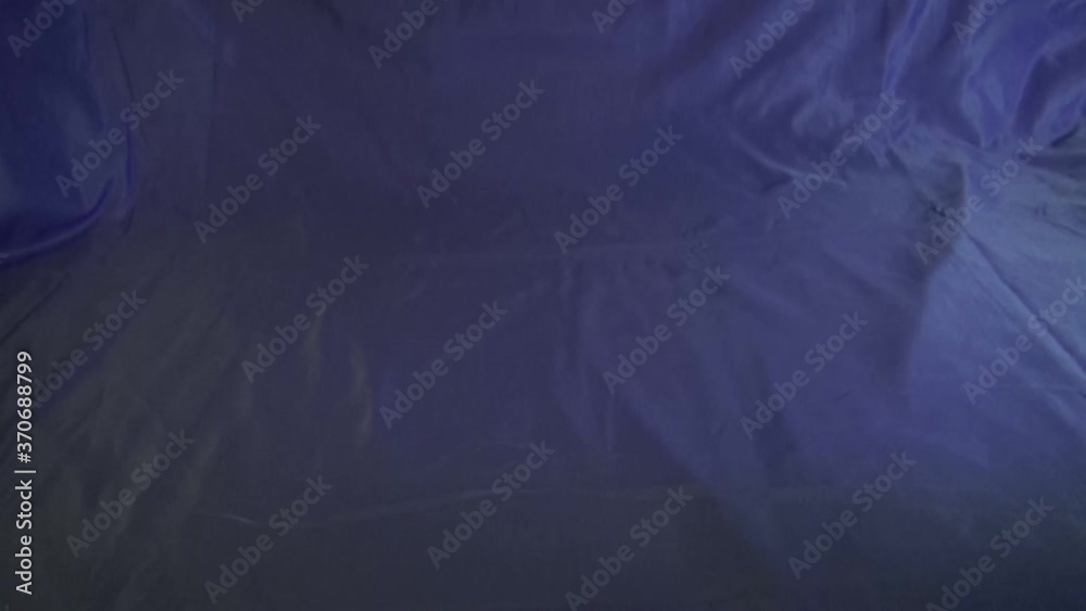 Chaotisch ausgekippte auf blauem Hintergrund in Zeitlupe. Bunte fliegende Kunstaufnahme. Klemmbausteine fallen runter in action. Buntes Spaß im Blauen.