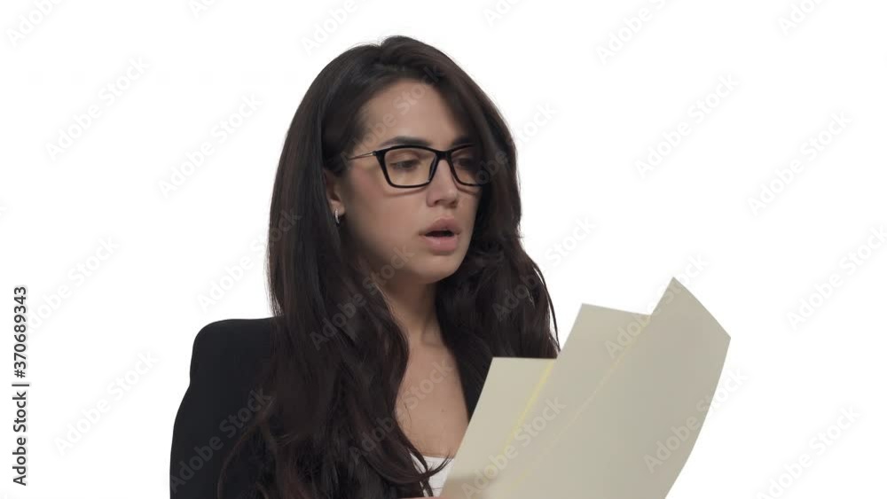 Portrait of annoyed Caucasian business lady in glasses examining documents and angrily throws them into camera. Isolated on white background Portrait of annoyed Caucasian business lady in glasses examining documents and angrily throws them into camera. Isolated on white background
