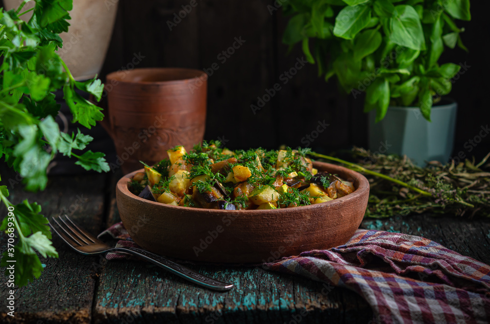 Vegetable roast eggplant and potatoes in a clay plate (ketsa). Homemade healthy food in a rustic style. Vegetable roast eggplant and potatoes in a clay plate (ketsa). Homemade healthy food in a rustic style.