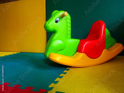 Rocking horse toys kid. children's playground, playroom with plastic colorful.