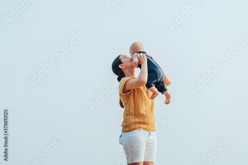 Happy family on the beach. Father, mother and baby having fun on summer vacation. Holiday travel concept