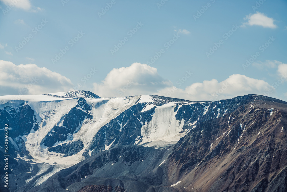 Atmospheric alpine view to big snowy mountains with glaciers. Scenic highland landscape with giant mountains with snow on tops. Awesome scenery of majestic nature. Snow on great rocks on high altitude