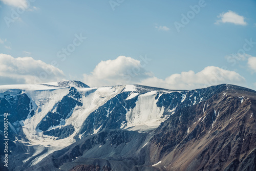 Atmospheric alpine view to big snowy mountains with glaciers. Scenic highland landscape with giant mountains with snow on tops. Awesome scenery of majestic nature. Snow on great rocks on high altitude