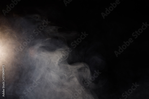 Dense Fluffy Puffs of White Smoke and Fog on Black Background