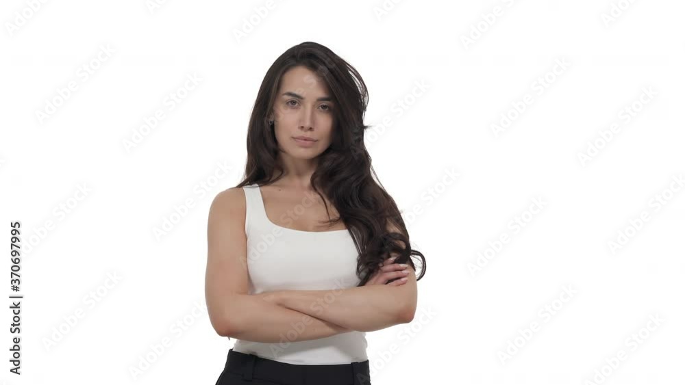 Young Caucasian woman standing with her back to camera, turns around and crossing arms with displeased look. Isolated on white background Young Caucasian woman standing with her back to camera, turns around and crossing arms with displeased look. Isolated on white background