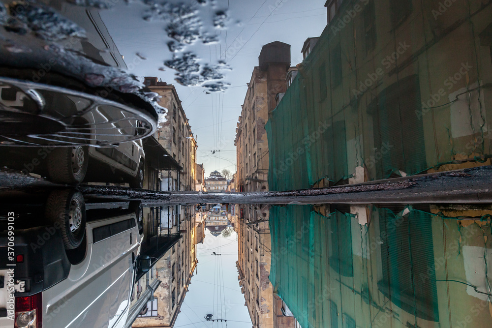 Slums reflected in a puddle