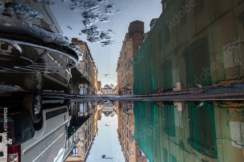 Slums reflected in a puddle