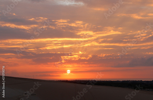 Beautiful sunrise with dramatic cloudscape at White Sand Dunes in Mui Ne  Vietnam