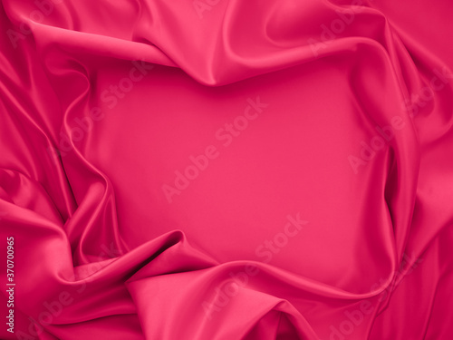 Beautiful elegant wavy fuchsia pink satin silk luxury cloth fabric texture, abstract background design. 