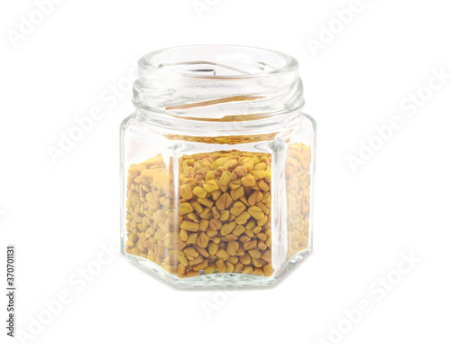 Fenugreek Seed (Methi Dana) Culinary Herb Spice in a Jar. Isolated on White Background.