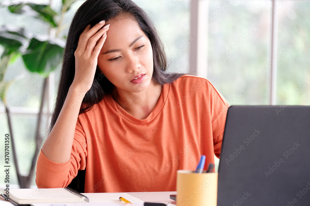 Stress asian woman struggle with laptop computer, Frustrated female at home office desk, People struggle with technology, Asia female overworked, exhausted and take a break while work from home Stress asian woman struggle with laptop computer, Frustrated female at home office desk, People struggle with technology, Asia female overworked, exhausted and take a break while work from home