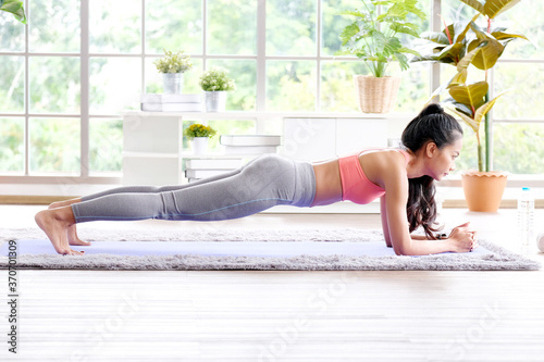 Exercise at home  Asian girl body doing plank while workout fitness  Healthy asia woman exercising in home living room  Female people training body weight