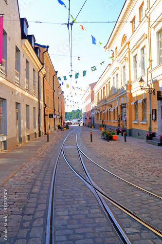 narrow cobbled street in Helsinki with tram rails