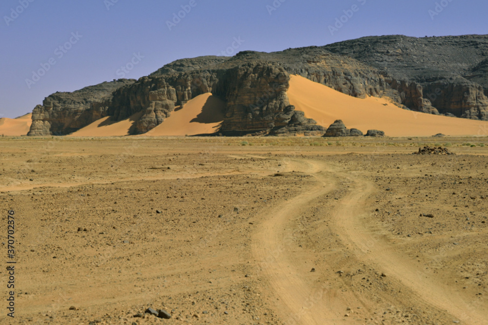 SAFARI IN THE SAHARA DESERT IN ALGERIA. TADRART NATIONAL PARK WITH SAND DUNES, ROCKS AND PREHISTORIC ROCK ART