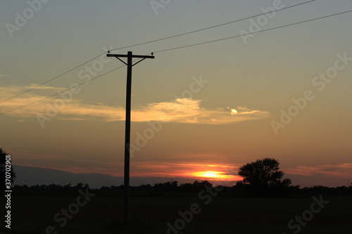 power lines at sunset in Kansas west of Sterling Kansas USA. © Stockphotoman