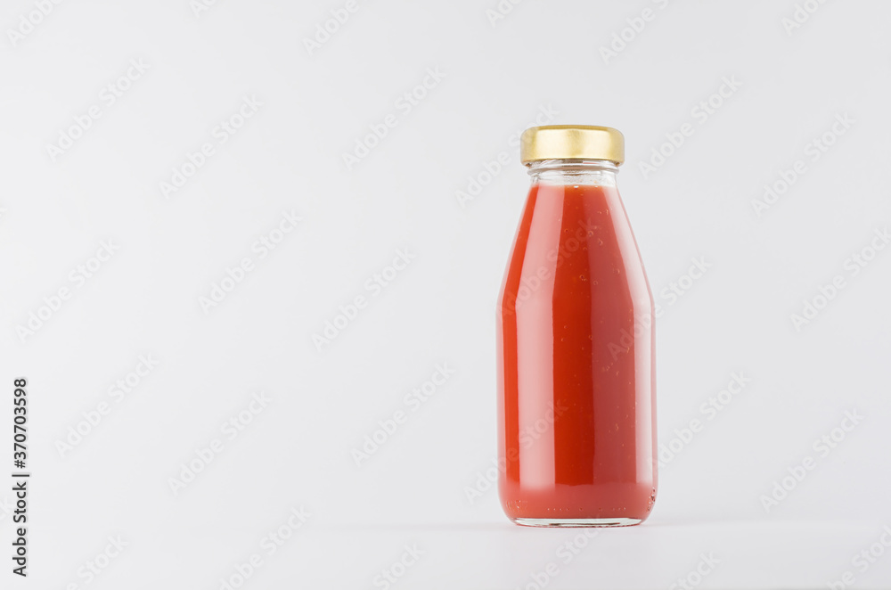 Red tomato juice in glass bottle with gold cap mock up on white background with copy space, template for packaging, advertising, design product, branding. Red tomato juice in glass bottle with gold cap mock up on white background with copy space, template for packaging, advertising, design product, branding.
