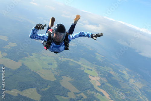 Skydiving. A military girl is flyingin the sky.