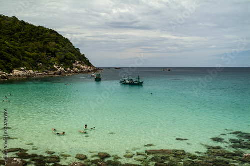 boulders and emerald sea on a beach at Koh Tao, Thailand