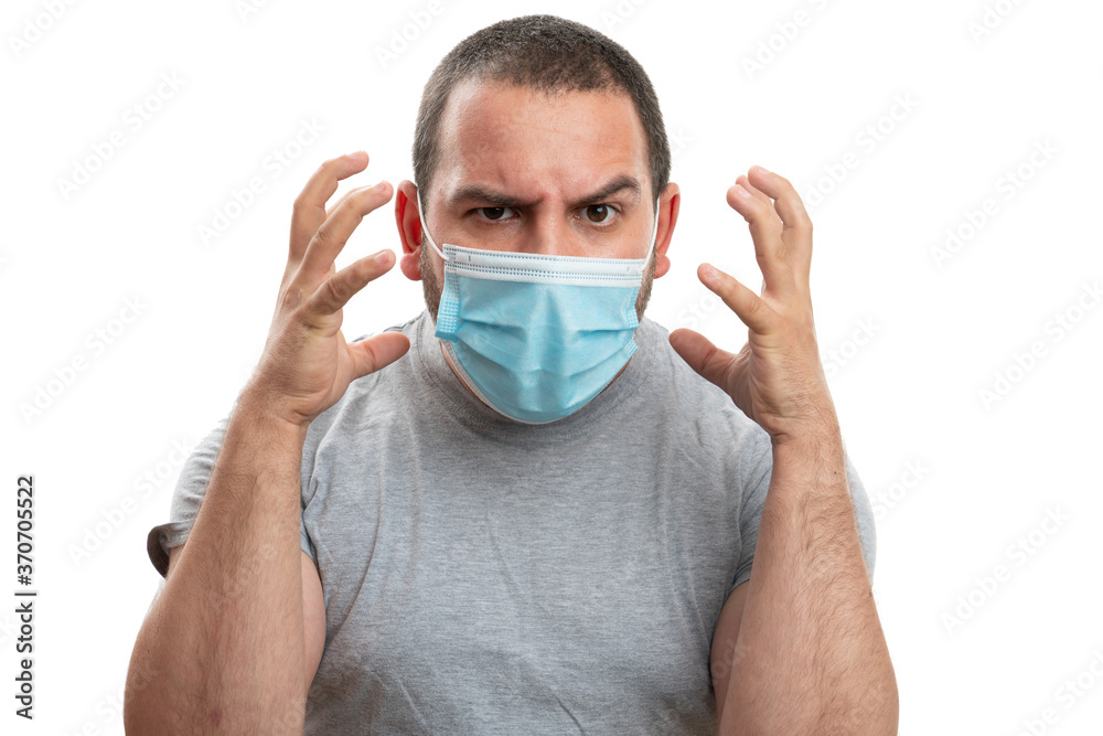 Adult wearing disposable prevention mask making angry gesture Adult wearing disposable prevention mask making angry gesture