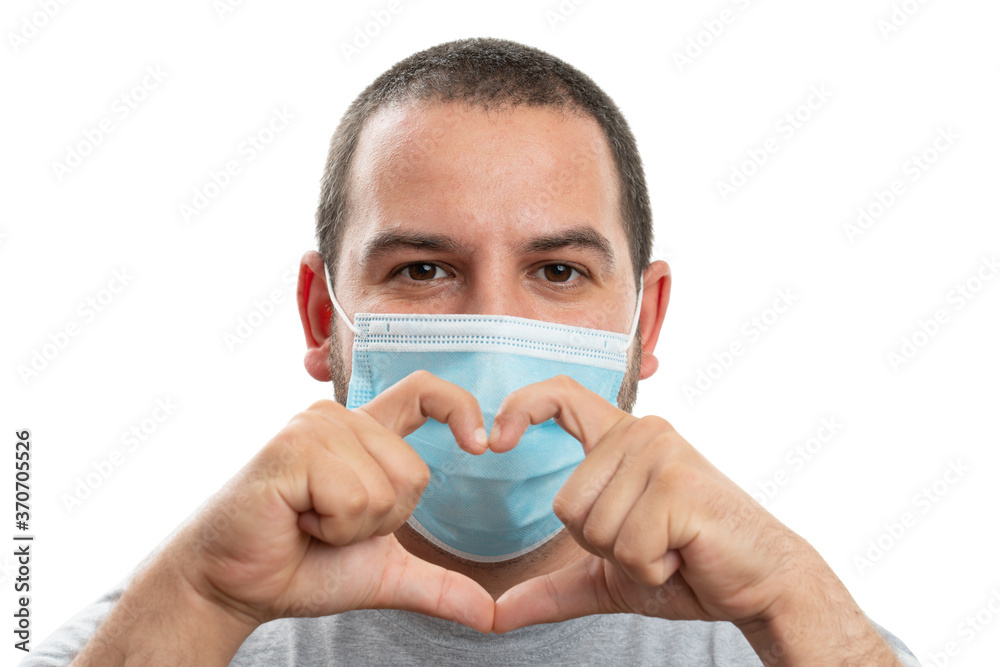 Man making heart symbol with hands wearing medical face covering Man making heart symbol with hands wearing medical face covering