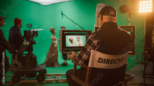 Director Shooting Period Film Green Screen CGI Scene with Actors Wearing Renaissance Costumes. Big Film Studio Professional Crew Shooting Big Budget Movie. Back View Shot photo