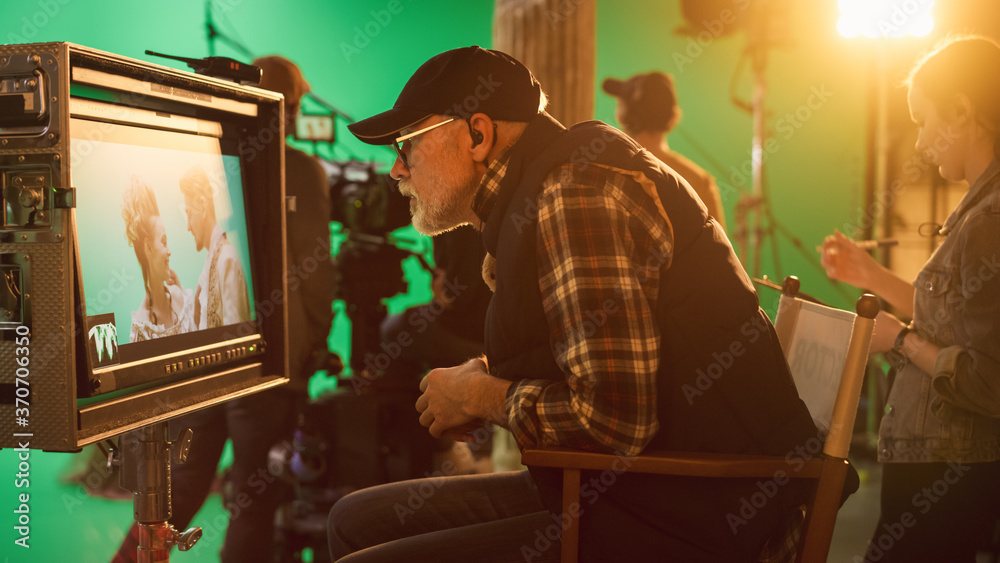 Director Looks at Display in Anger, Swears while Shooting Blockbuster Movie. Green Screen Scene with Actors Wearing Costumes. On Film Studio Set Professional Crew Doing High Budget Movie