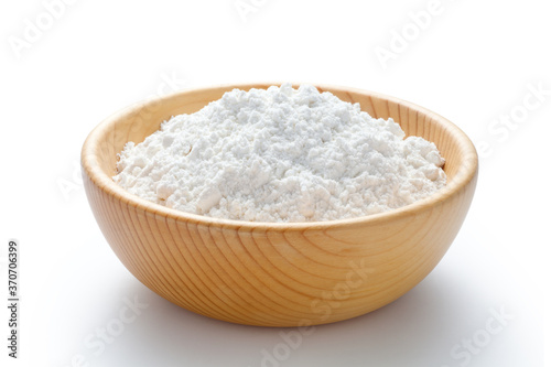 wheat flour in a wooden bowl isolated on white background