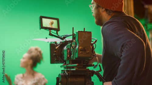 Quadro em tela Portrait of Cameraman on Railway Trolley Shooting Green Screne Scene