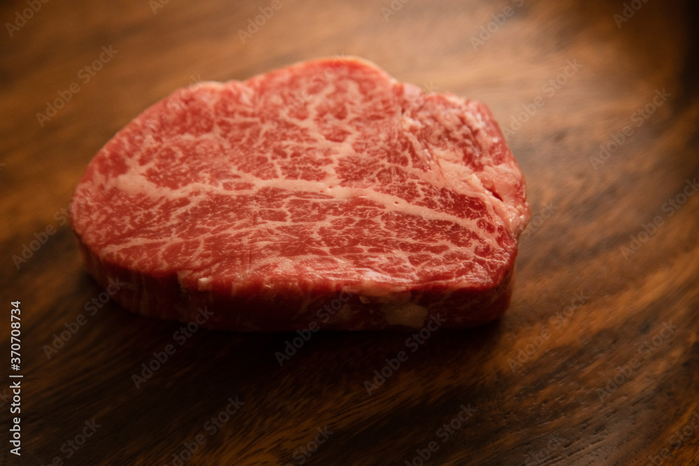 Fillet steak on wooden plate
