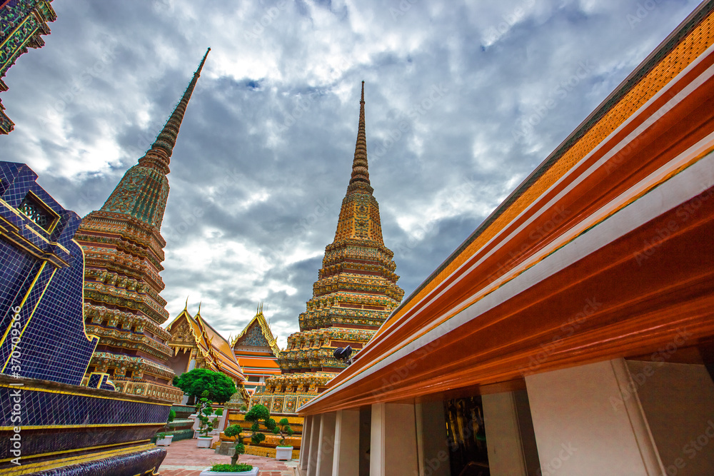 Fototapeta premium background of important religious attractions in Bangkok (Wat Phra Chetuphon (Wat Pho - reclining Buddha), a large pagoda and beautiful sculptural art give future generations to explore its history