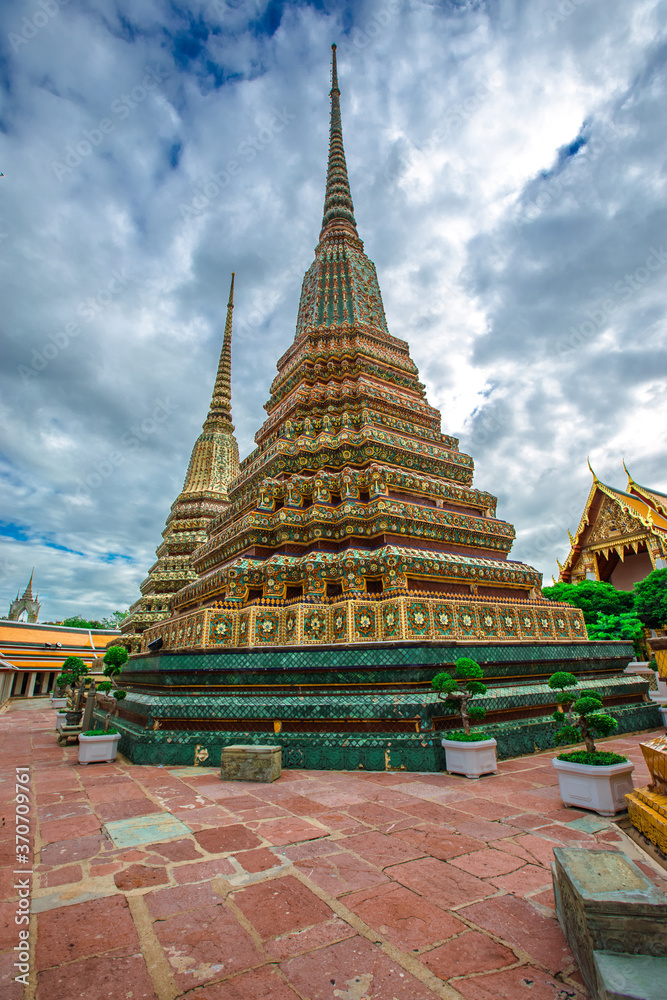 Fototapeta premium background of important religious attractions in Bangkok (Wat Phra Chetuphon (Wat Pho - reclining Buddha), a large pagoda and beautiful sculptural art give future generations to explore its history