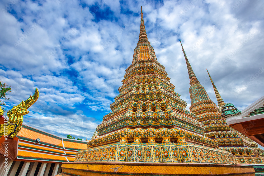 Fototapeta premium background of important religious attractions in Bangkok (Wat Phra Chetuphon (Wat Pho - reclining Buddha), a large pagoda and beautiful sculptural art give future generations to explore its history