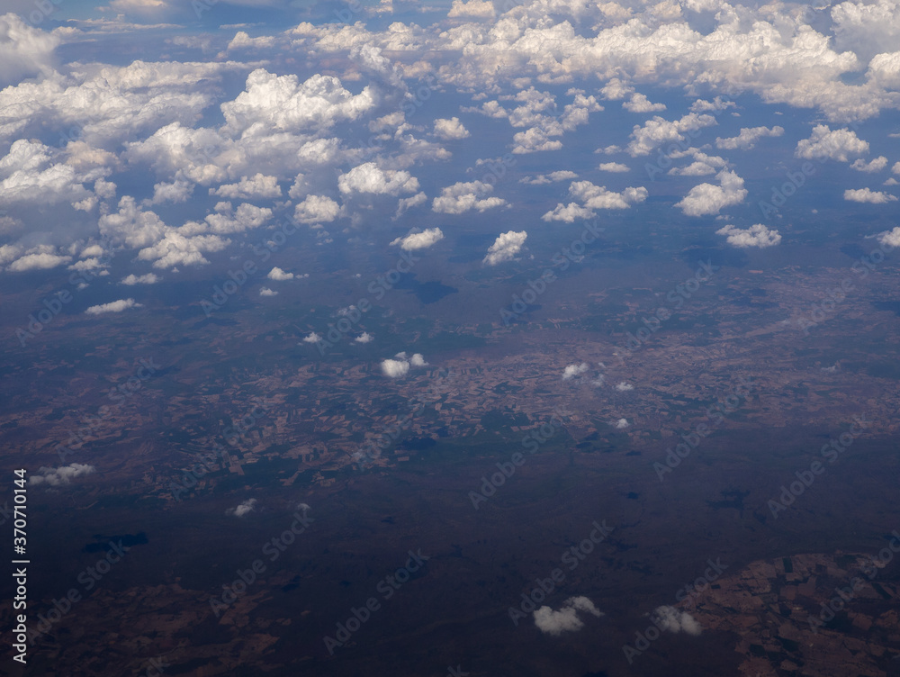 view from the airplane window, above the clouds and sky