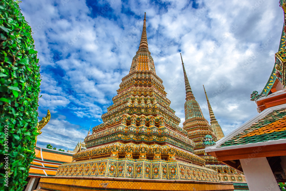 Fototapeta premium background of important religious attractions in Bangkok (Wat Phra Chetuphon (Wat Pho - reclining Buddha), a large pagoda and beautiful sculptural art give future generations to explore its history