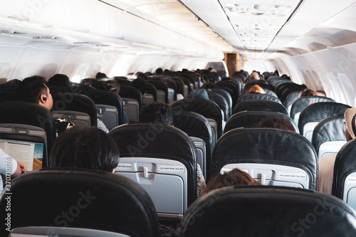 Obraz na plátně Interior of a plane with passengers on their seats .