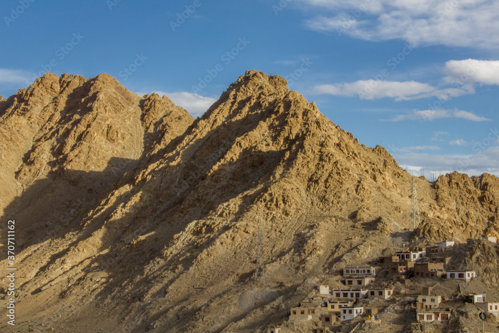 simple houses on the ridge of a sandy mountain