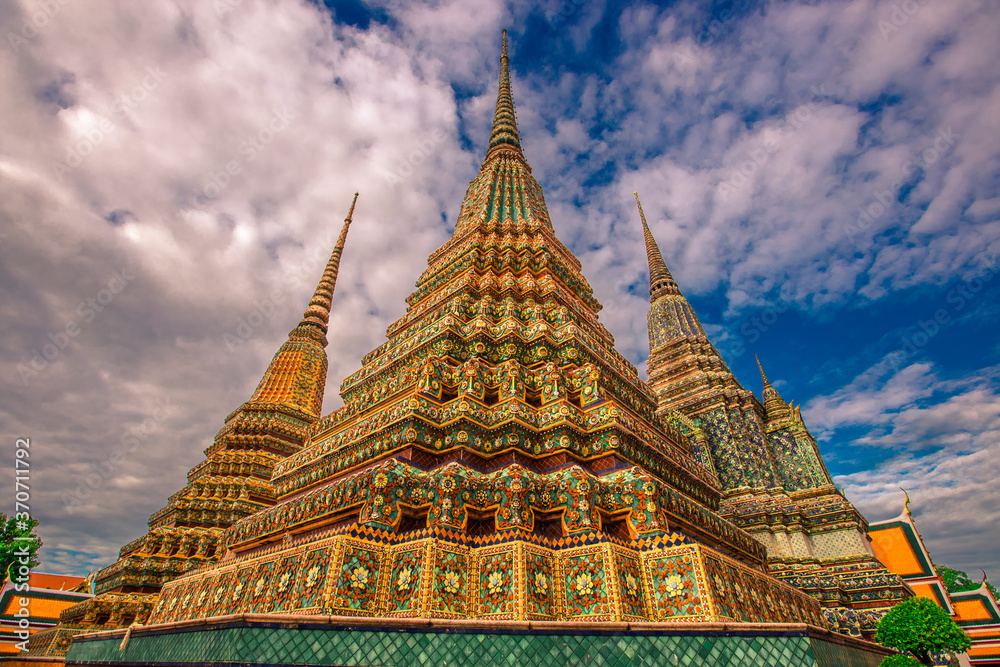 Fototapeta premium background of important religious attractions in Bangkok (Wat Phra Chetuphon (Wat Pho - reclining Buddha), a large pagoda and beautiful sculptural art give future generations to explore its history