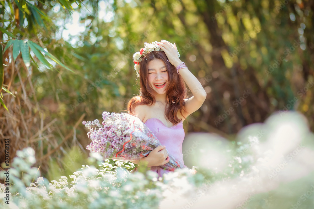 Fototapeta premium Beautyful Asian woman in the flower garden