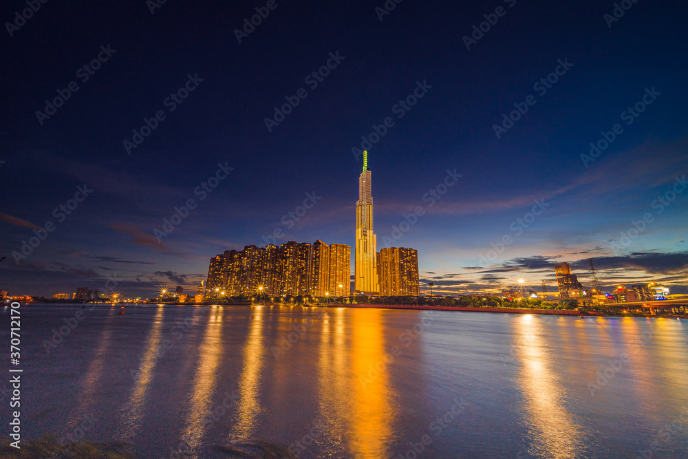 Sunset at Landmark 81 is a super tall skyscraper in center Ho Chi Minh City, Vietnam and Saigon bridge with development buildings, energy power infrastructure.