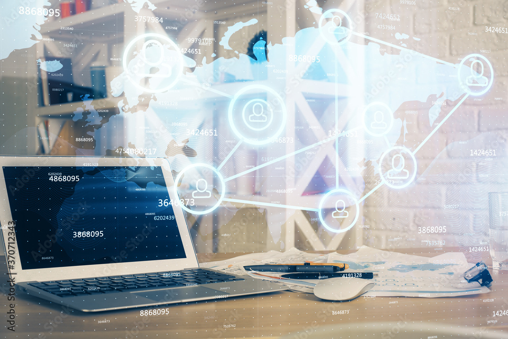Computer on desktop with social network hologram. Multi exposure. Concept of international people connections. Computer on desktop with social network hologram. Multi exposure. Concept of international people connections.