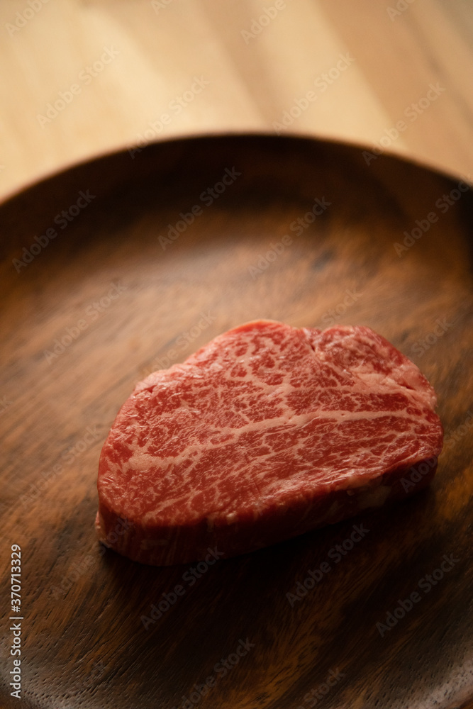 Beef fillet steak on the wooden plate Beef fillet steak on the wooden plate