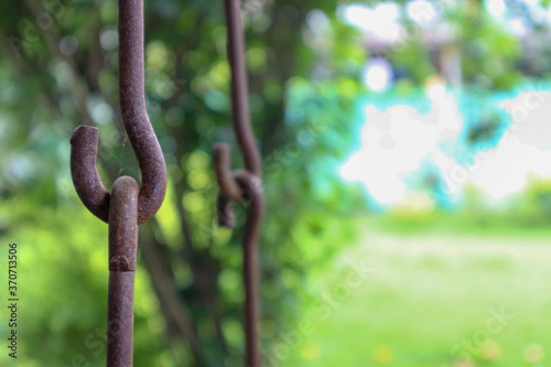 Rusty metallic chains holding together. Swing metal chain Links closeup.