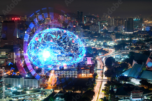 Human brain hologram, aerial panoramic city view of Kuala Lumpur at night. KL is the educational cluster in Malaysia, Asia. The concept of artificial intelligence. Double exposure.