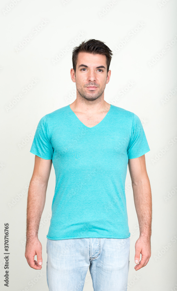 Obraz premium Portrait of young handsome Hispanic man against white background