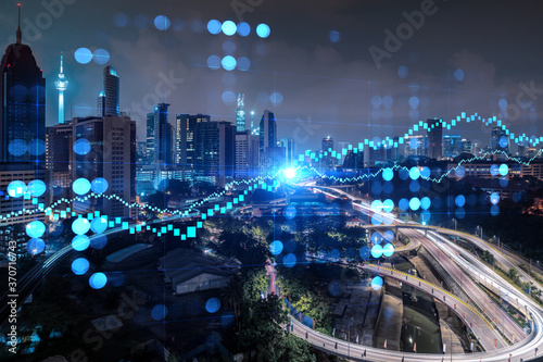 Photography FOREX graph hologram, aerial night panoramic cityscape of Kuala Lumpur