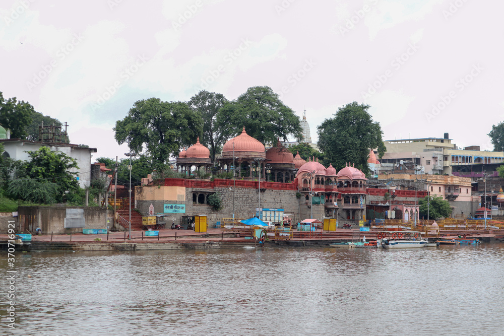 Fototapeta premium Ujjain, India - August 8th 2020: Ram ghat on shipra river with temples on the shore