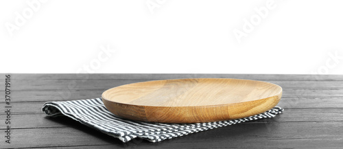 Empty plate and napkin on dark wooden table