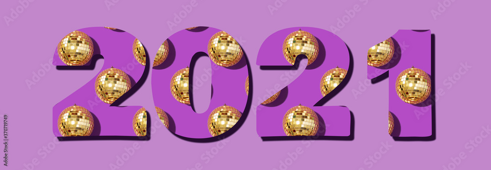 Figures 2021 for your design. Creative Christmas pattern. Inscription 2021 made with shiny gold disco balls over violet background. New year baubles, star sparkles. Cristmas greeting card Figures 2021 for your design. Creative Christmas pattern. Inscription 2021 made with shiny gold disco balls over violet background. New year baubles, star sparkles. Cristmas greeting card
